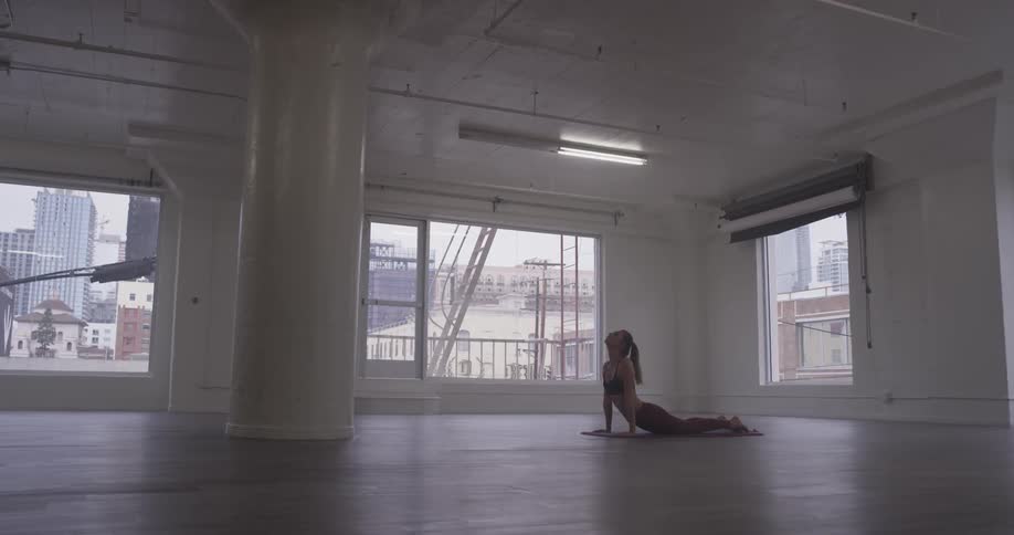 Woman Doing Yoga In Empty Building