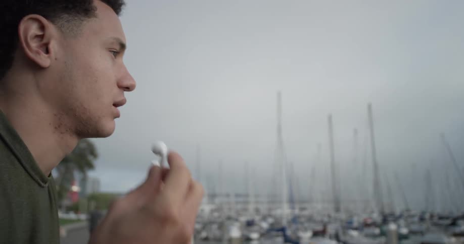 A man looking at boats at a pier