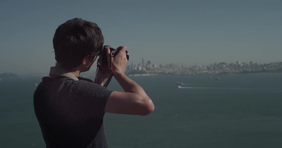 Man takes pictures of the bay and the city