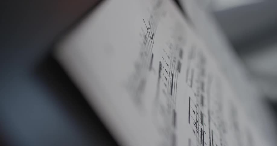 A close up of sheet music pages being turned
