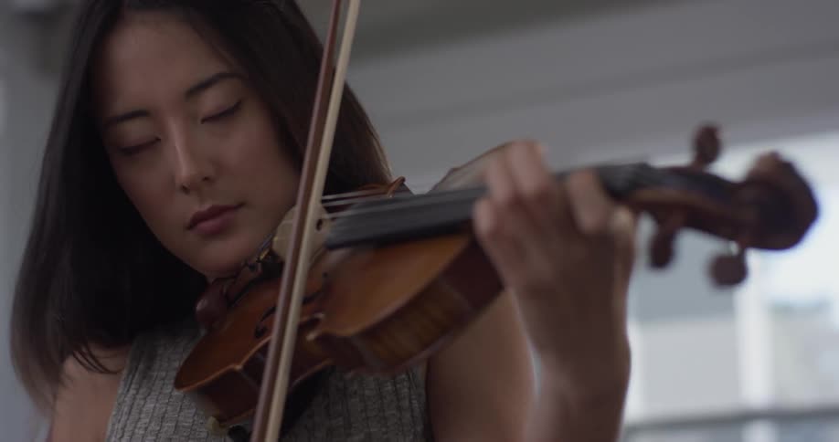 A woman is playing an instrument inside