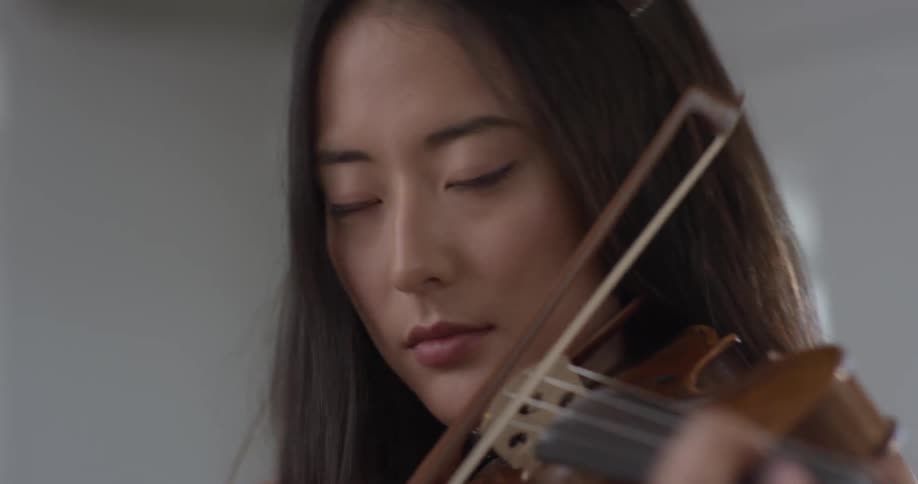 Woman playing a violin and dancing