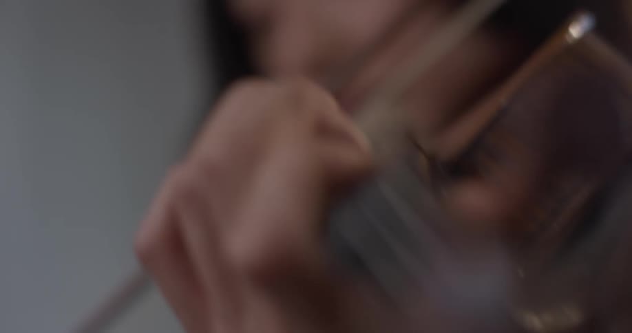 Woman plays the violin swaying back and forth