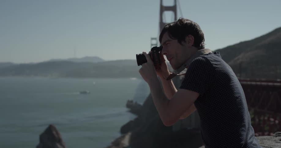 A man is outside and is taking pictures