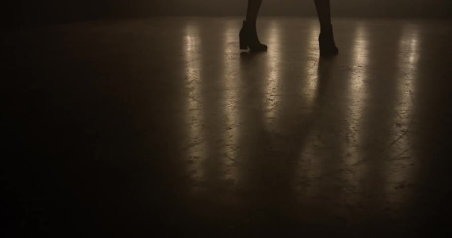 Person dances in a dark room