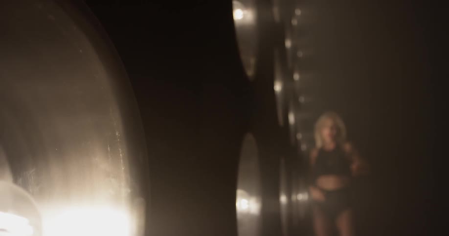 A woman dancing in front of a lot of lights