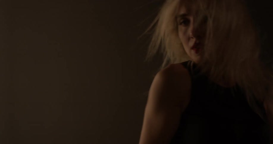 Woman dances in a room lit up with many lights