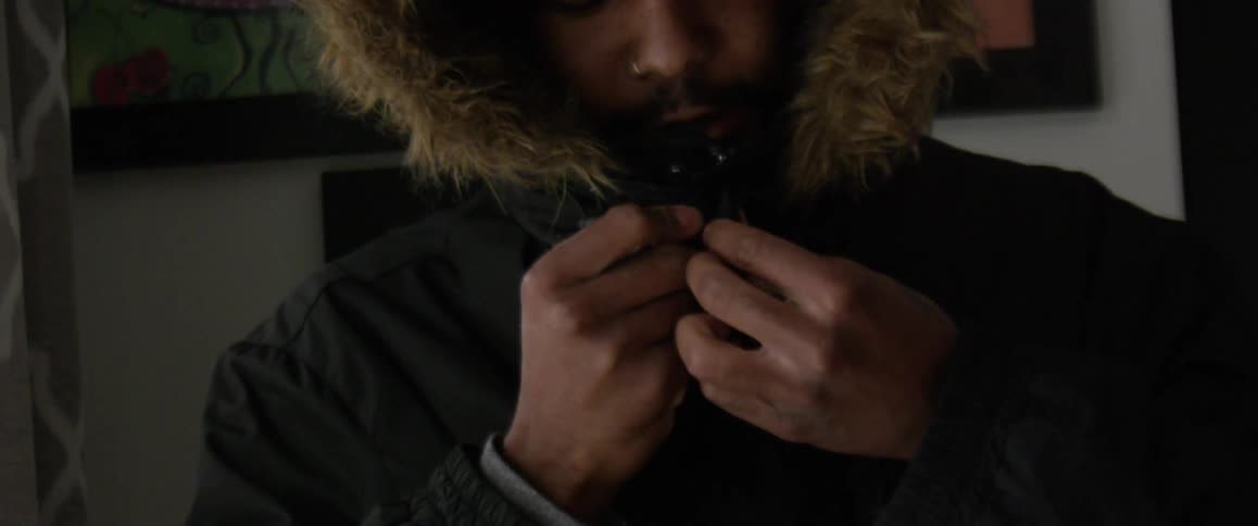 A man is getting dressed