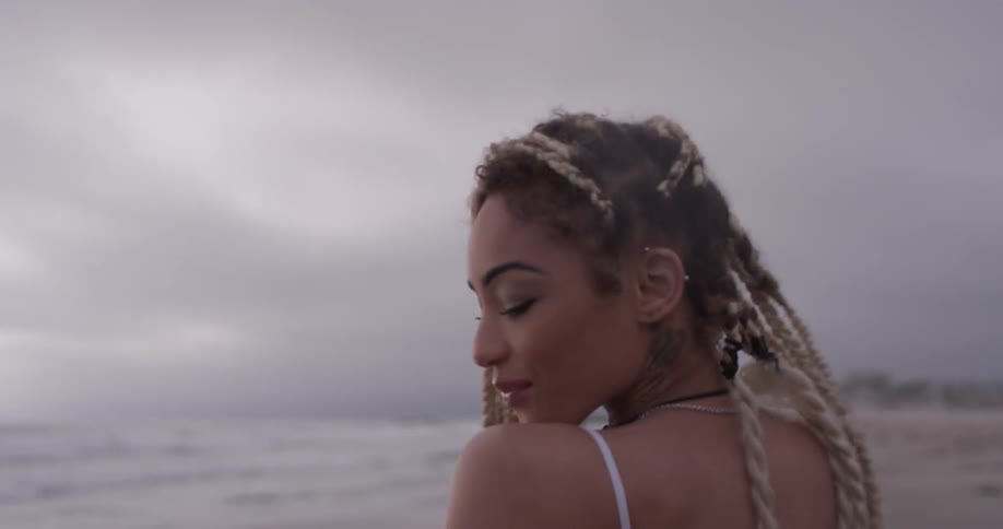 Woman turns around smiling on the beach