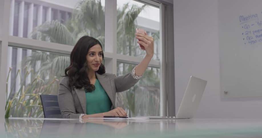 A woman taking a photo of herself with her phone