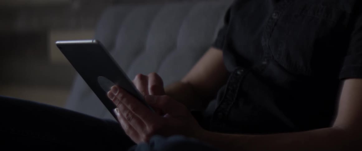 Arms and hands of a man, while he works on an ipad