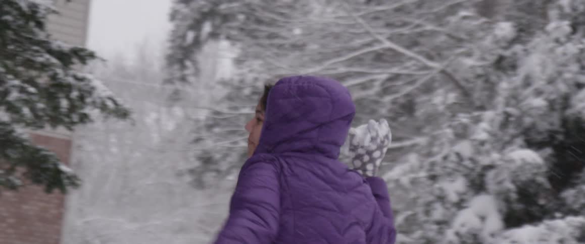 A child is running in the snow