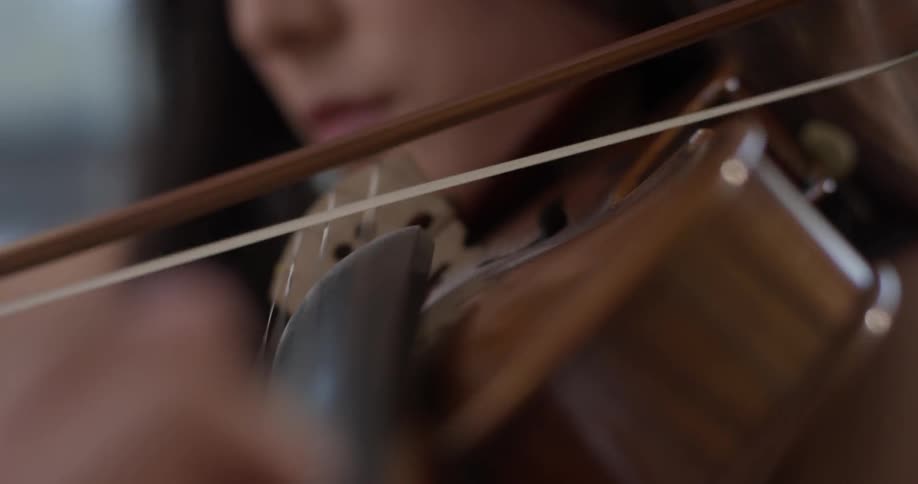 A woman is playing an instrument inside