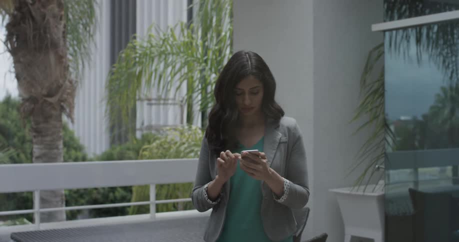 Woman typing on her cell phone