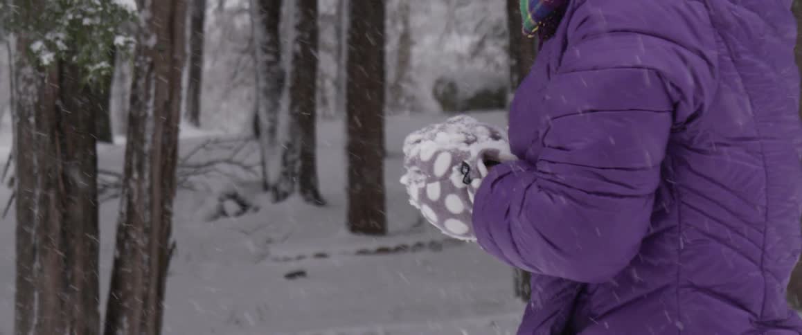 A woman is playing with snow