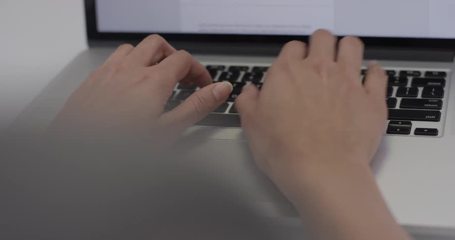 A person typing on a laptop