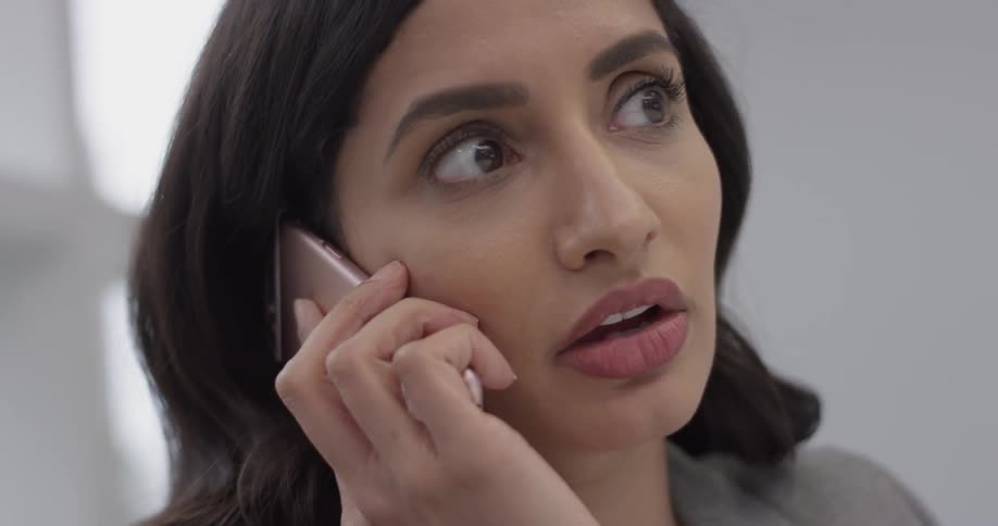 Woman talking into a cell phone and nodding along