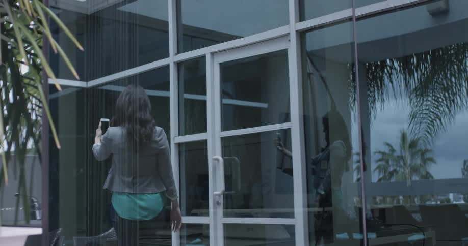 A woman does a video chat outside a building