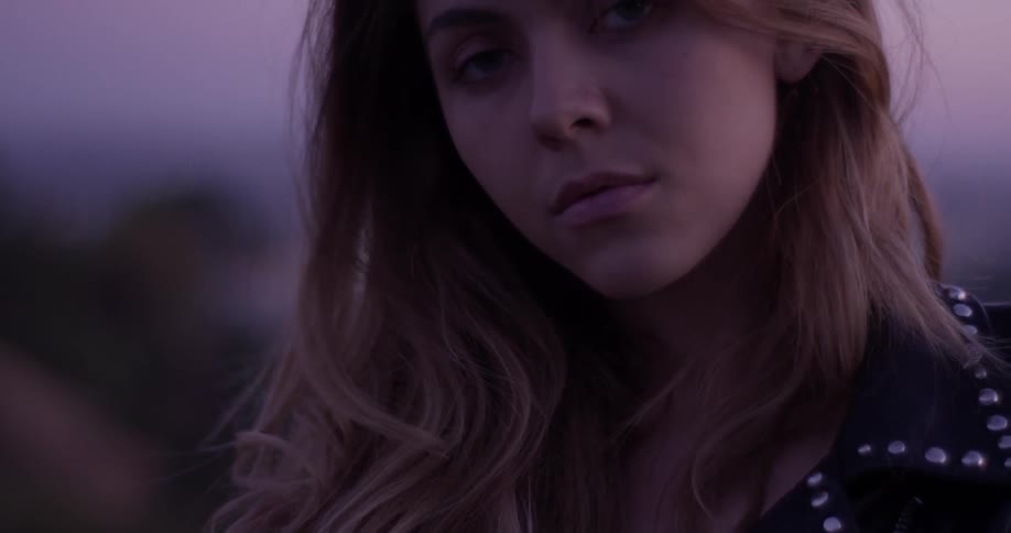 A woman looking into the distance at sunset