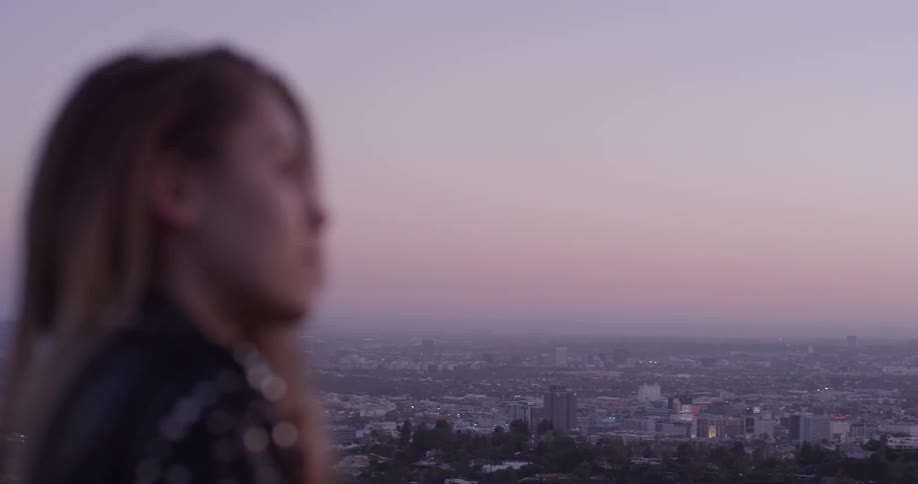 A woman is outside looking at the horizon