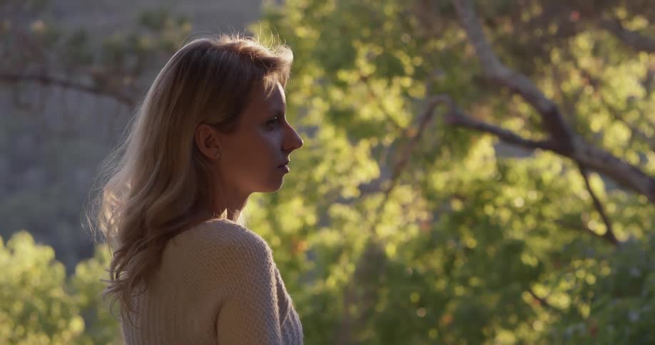 A woman looks at the trees