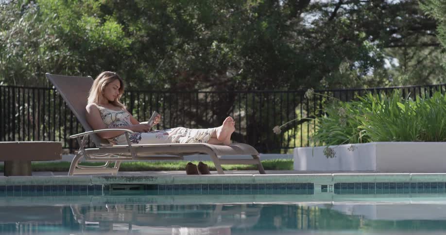 Woman Relaxing By The Pool