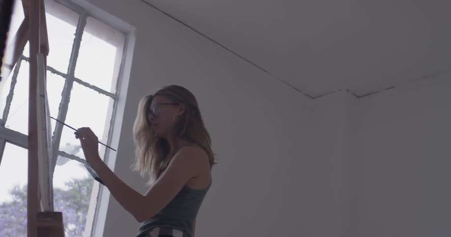A woman painting in an art studio