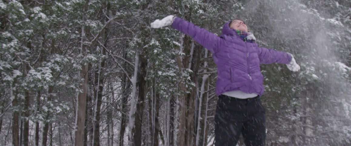A girl is having fun playing with snow