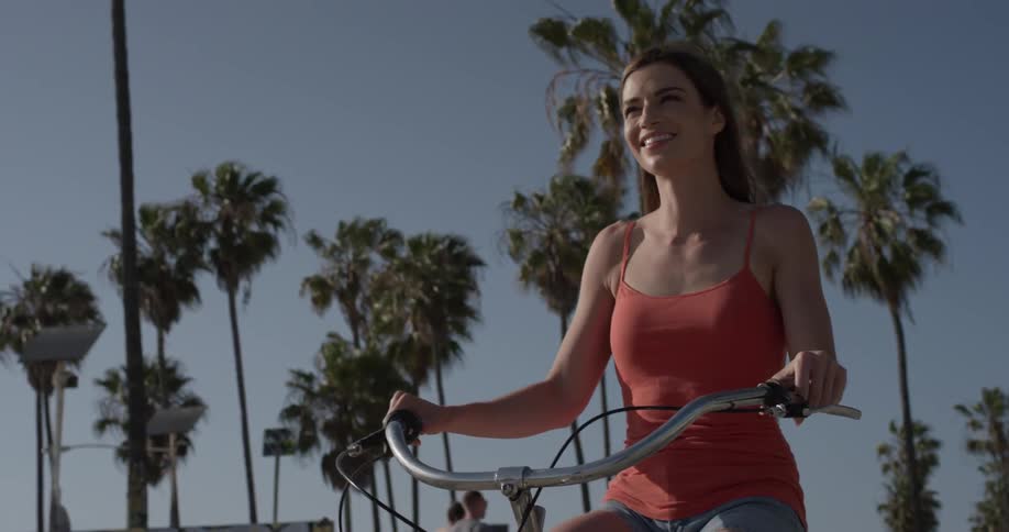 A woman riding a bicycle outdoors