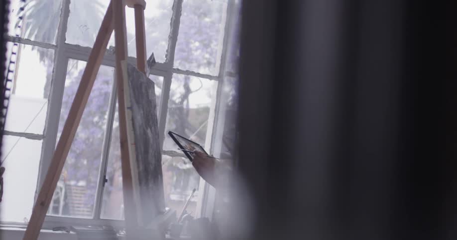 A woman in an art studio painting