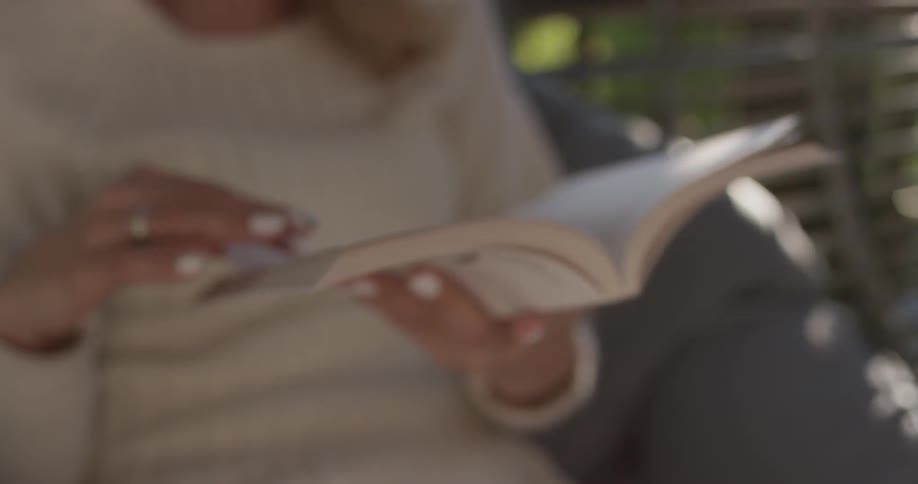 A woman reading a book outside