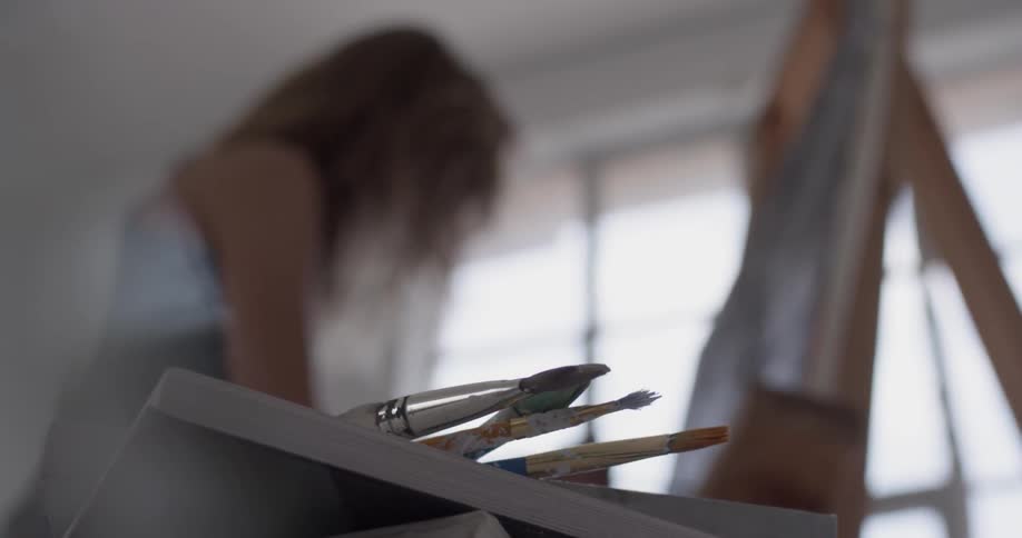 A woman painting in an art studio
