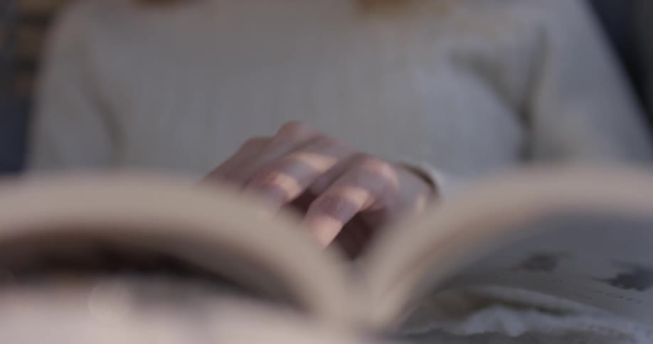 Woman reading a book in a chair