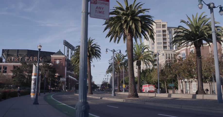 People jogging down a sidewalk next to a street