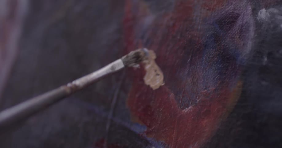 A person painting on a canvas