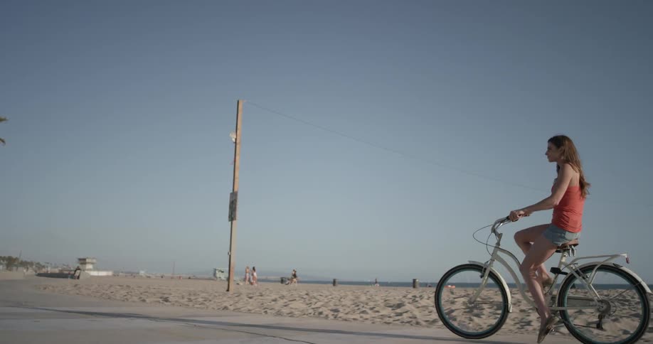 A woman is riding a bicycle outside
