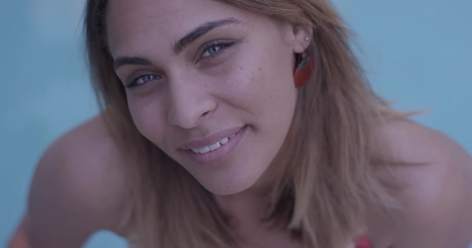 Woman looking up at at the camera and smiling playfully and flirty