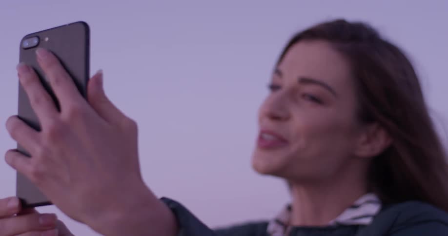 A woman using her phone to video call someone