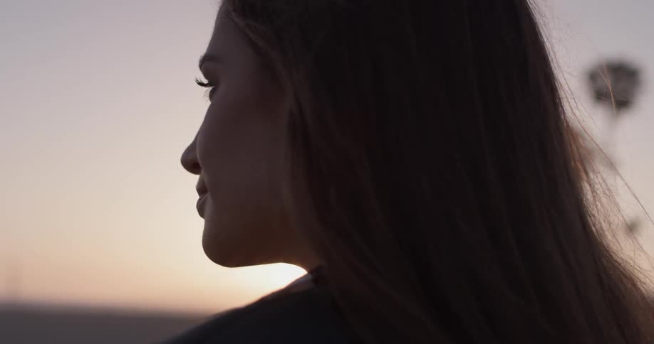 Woman smiling and looking at the beach