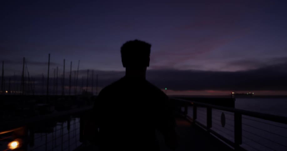 A man is jogging outside at night