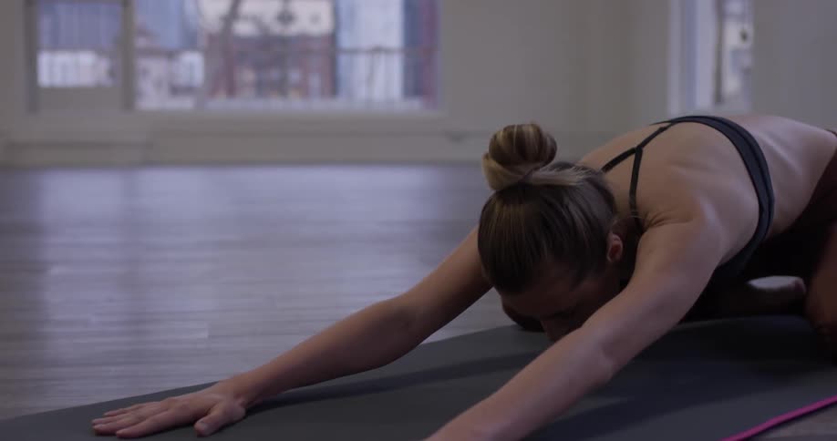 Woman Doing Yoga In Empty Building