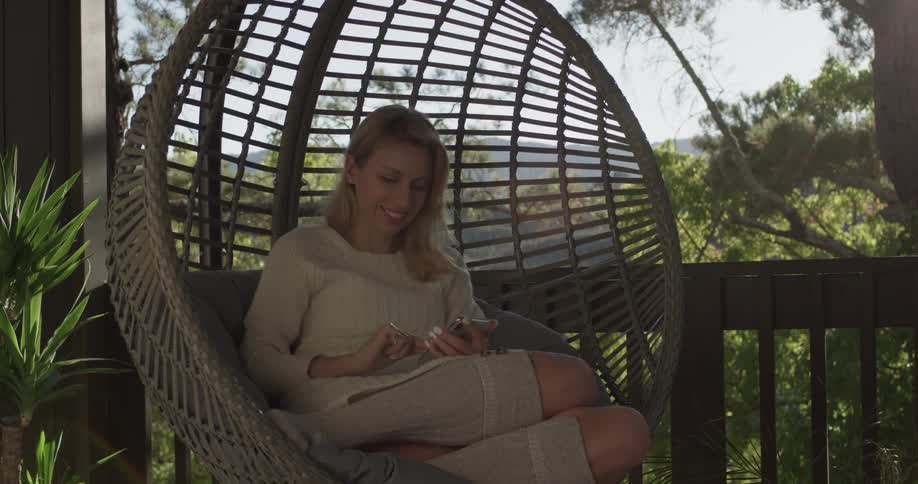Woman sitting in a swinging chair