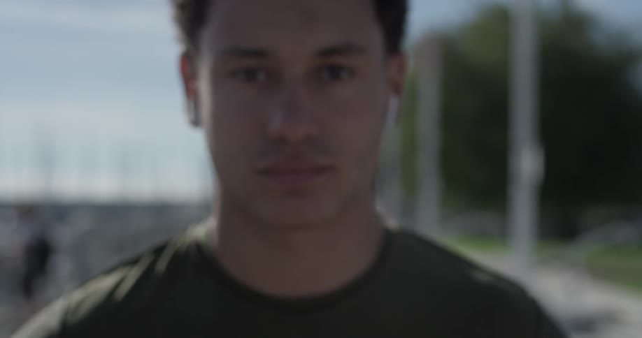 A man walking with headphones in his ears