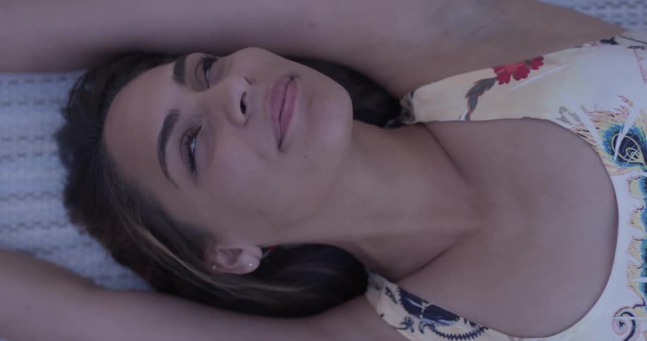 A woman is laying down and stretching