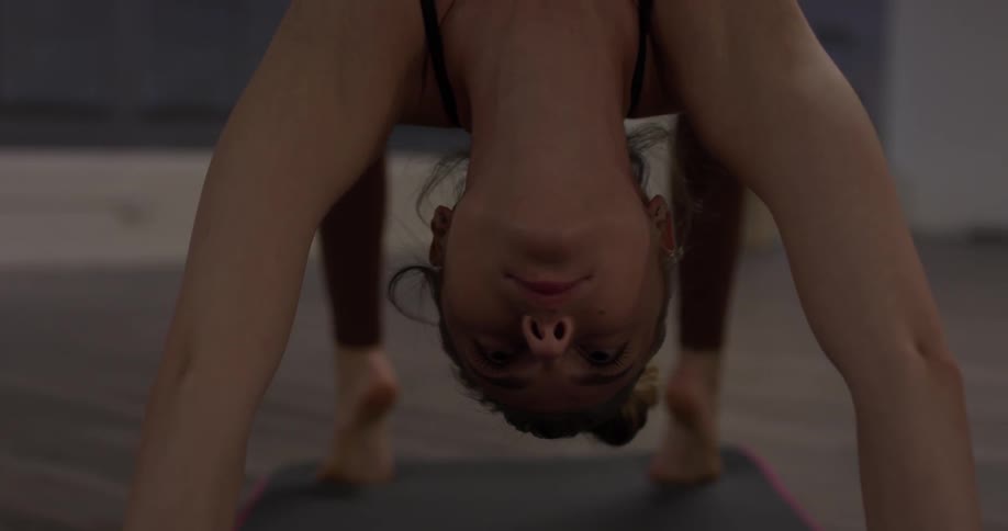 A woman lifts her body off the floor, with her hands and feet