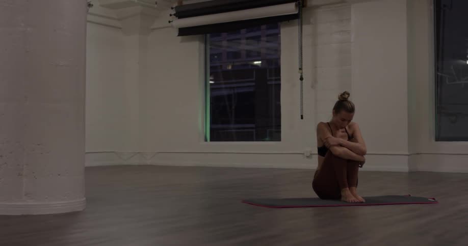 Woman Doing Yoga In Empty Building