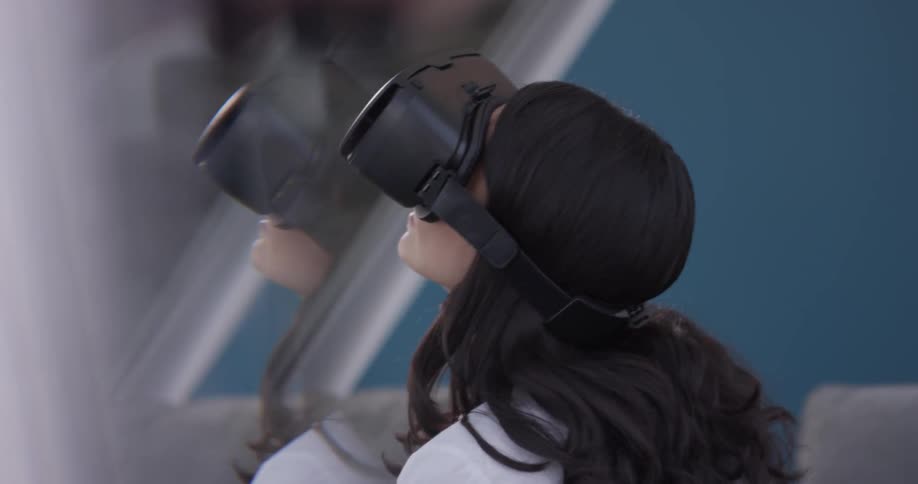 A woman is seen in double through a reflection wearing virtual reality goggles