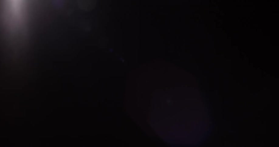 A dim light is shining in a dark room