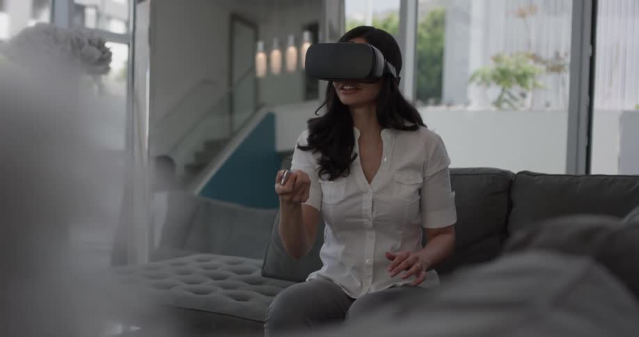 A woman using a remote and virtual reality visor