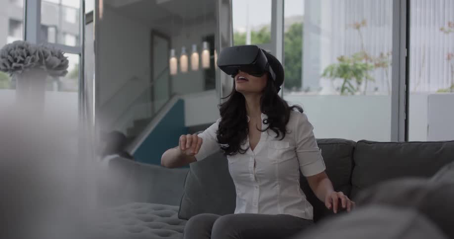 Woman using a vr headset on a couch